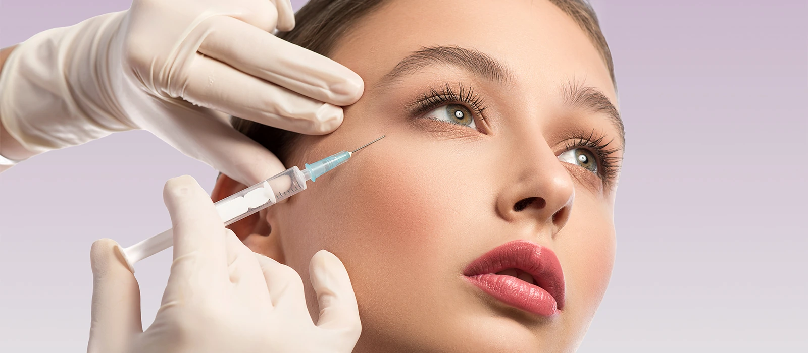 closeup of woman receiving hyaluronic acid in cheekbone area