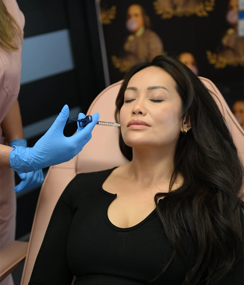 female client receiving injectables to treat smile lines