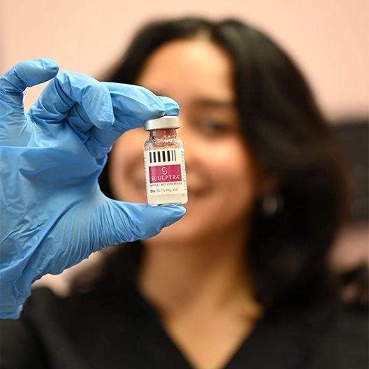 dermfx provider holding vial of sculptra filler