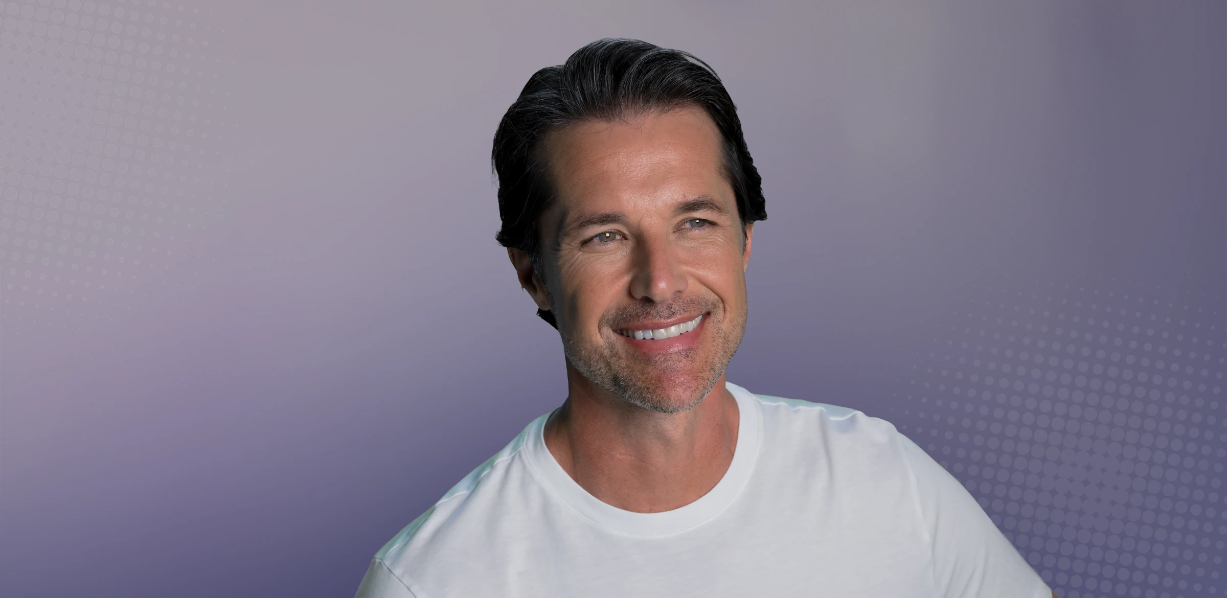 male client smiling with healthy skin and hair