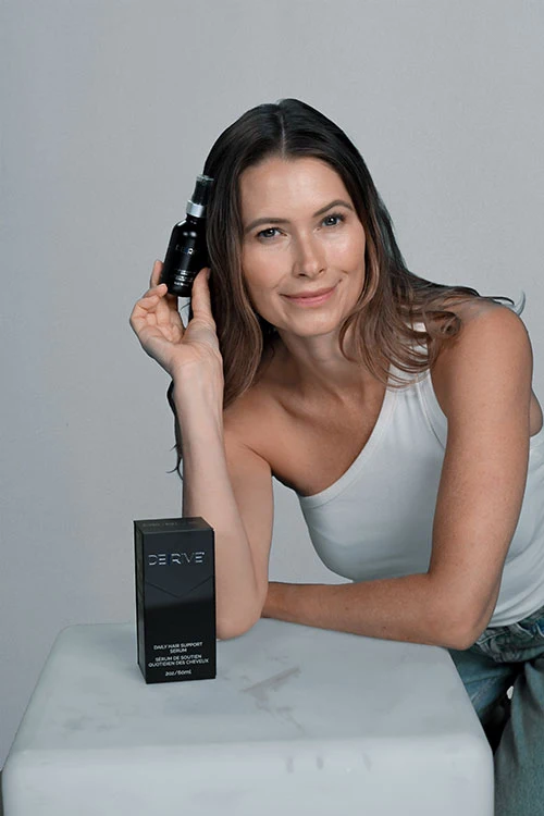 Client holding hair serum