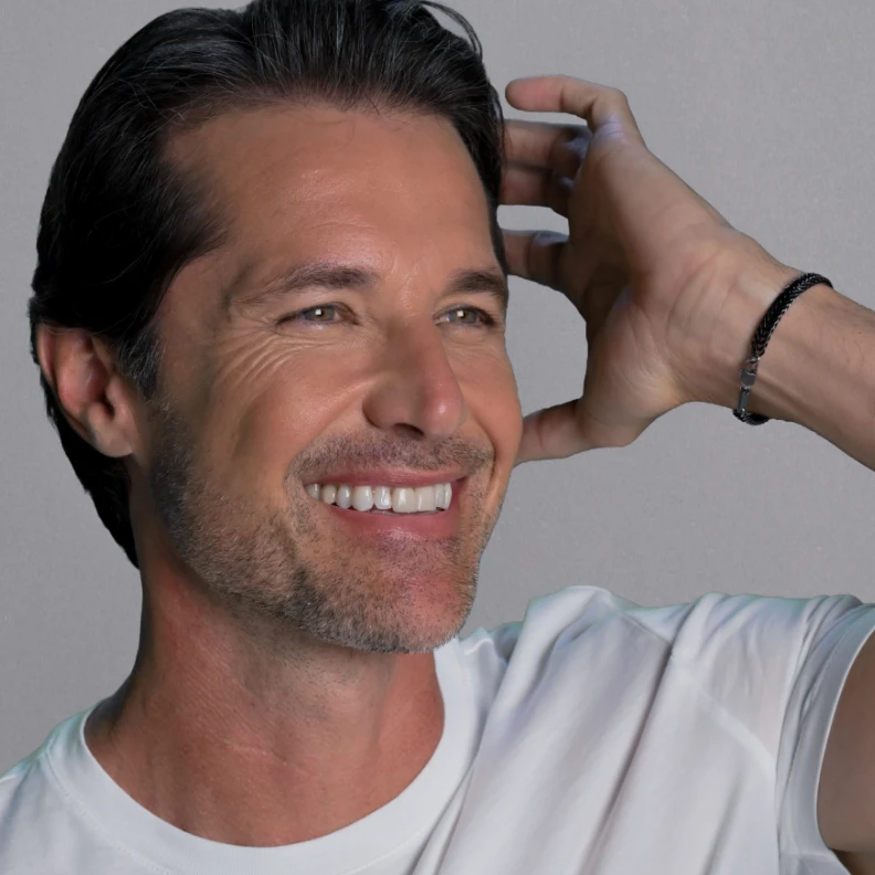 male client with radiant skin and touching hair